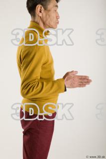 Arm flexing reference of yellow sweater red trousers Sidney 0013